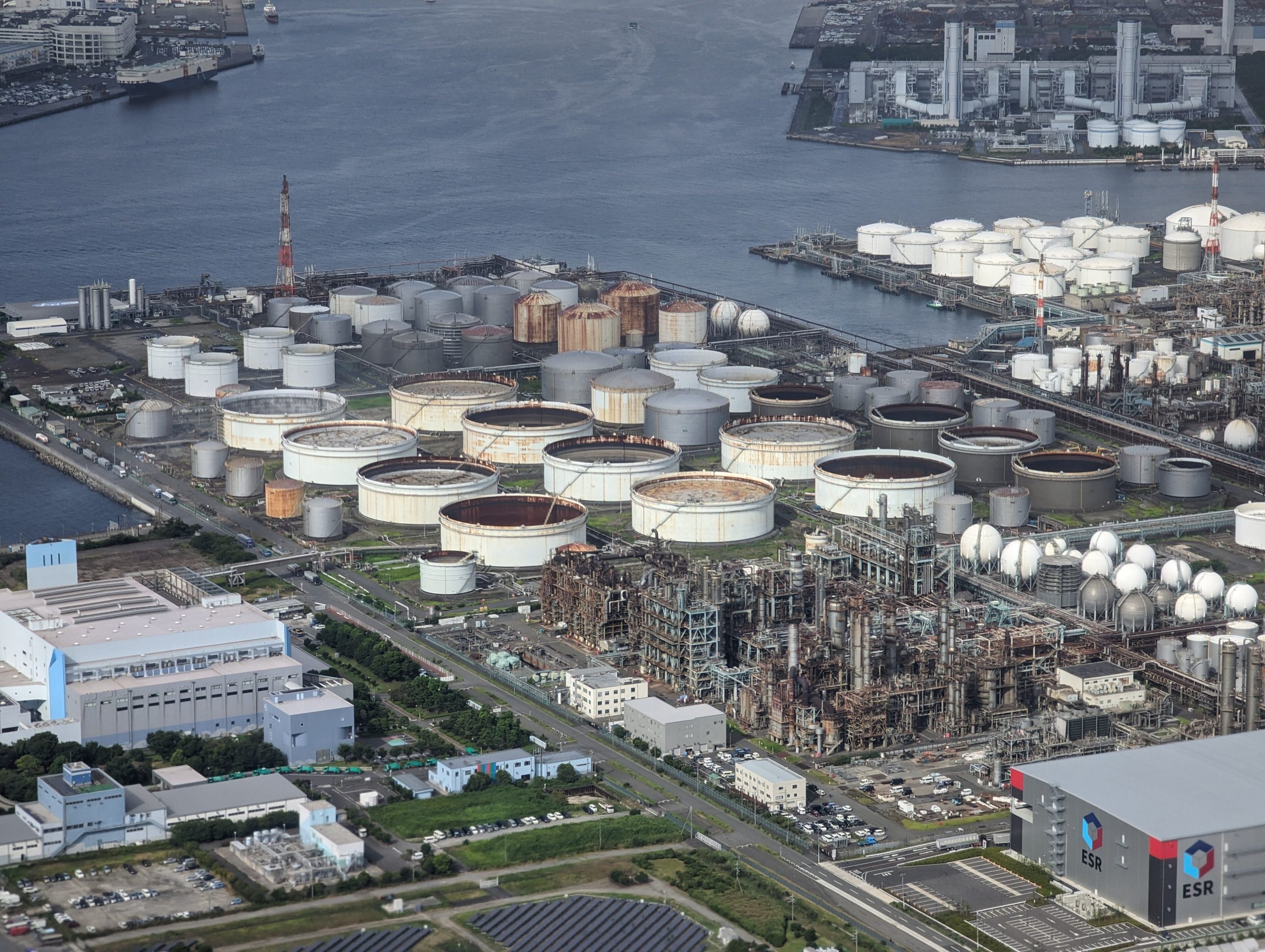 Aerial view of an industrial port with tank terminals